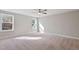 Spacious bedroom with neutral carpet, ceiling fan, and bright natural light at 594 Executive Dr, Lillington, NC 27546