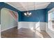 Bright dining room with wainscoting, coffered ceilings, and wood-look floors at 594 Executive Dr, Lillington, NC 27546