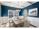 Dining room with wainscoting, coffered ceilings, and a wooden table set for six at 594 Executive Dr, Lillington, NC 27546