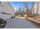 Spacious driveway leading to garage and yard with storage shed in background at 594 Executive Dr, Lillington, NC 27546