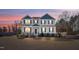 Beautiful two-story home with blue shutters, a covered porch, and a manicured lawn at 594 Executive Dr, Lillington, NC 27546