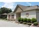 Exterior view of the clubhouse with inviting landscaping and convenient parking at 594 Executive Dr, Lillington, NC 27546