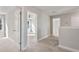 Upstairs hallway featuring neutral carpet and bright natural light at 594 Executive Dr, Lillington, NC 27546