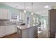 Bright kitchen featuring white cabinets, gray countertops, and stainless steel appliances at 594 Executive Dr, Lillington, NC 27546