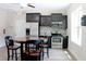 Clubhouse kitchenette with stainless steel appliances, modern cabinetry, and a cozy dining area at 594 Executive Dr, Lillington, NC 27546
