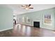 Bright living room featuring hardwood floors, fireplace, ceiling fan, and natural light at 594 Executive Dr, Lillington, NC 27546
