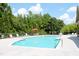Community pool with lounge chairs, lush greenery, and a refreshing aquatic retreat at 594 Executive Dr, Lillington, NC 27546