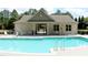 Inviting community pool with accessibility features, sun loungers, and a nearby clubhouse at 594 Executive Dr, Lillington, NC 27546
