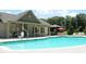 Resort-style pool area, featuring a gazebo, clubhouse, and relaxing lounge chairs at 594 Executive Dr, Lillington, NC 27546