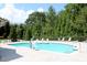 Inviting community pool surrounded by lush landscaping and comfortable lounge chairs at 594 Executive Dr, Lillington, NC 27546