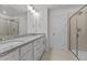 Well-lit bathroom with granite counters, double sinks, and a walk-in shower at 945 Alma Railway Dr # 559, Wake Forest, NC 27587