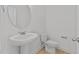 Bright bathroom features a pedestal sink, white toilet, and neutral tones for a clean, modern aesthetic at 945 Alma Railway Dr # 559, Wake Forest, NC 27587