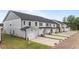 A row of newly constructed townhomes, each with a two-car garage and manicured lawns, showcasing modern curb appeal at 945 Alma Railway Dr # 559, Wake Forest, NC 27587
