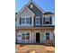 Two-story home featuring large windows, shutters, and a covered front porch during construction phase at 945 Alma Railway Dr # 559, Wake Forest, NC 27587