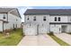 New townhome exterior featuring light gray siding, black roof, and two car garage for modern living at 945 Alma Railway Dr # 559, Wake Forest, NC 27587