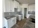 Bright kitchen featuring white cabinets, gray backsplash, and granite countertops, creating a modern look at 945 Alma Railway Dr # 559, Wake Forest, NC 27587