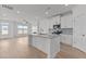 Open-concept kitchen with island, stainless steel appliances, and seamless flow to the living area at 945 Alma Railway Dr # 559, Wake Forest, NC 27587
