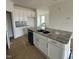 Kitchen featuring white cabinetry, granite island, and stainless steel appliances at 945 Alma Railway Dr # 559, Wake Forest, NC 27587