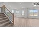 Bright, open-concept living room with wood-look flooring and staircase at 945 Alma Railway Dr # 559, Wake Forest, NC 27587