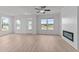 Comfortable living room with an electric fireplace, ceiling fan, and lots of natural light at 945 Alma Railway Dr # 559, Wake Forest, NC 27587