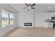 Bright, open-concept living space featuring a modern fireplace and large windows at 945 Alma Railway Dr # 559, Wake Forest, NC 27587