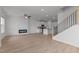 Spacious living area seamlessly connecting the kitchen with fireplace and a staircase at 945 Alma Railway Dr # 559, Wake Forest, NC 27587
