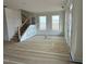 Spacious living room featuring large windows and a staircase at 945 Alma Railway Dr # 559, Wake Forest, NC 27587