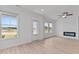 Bright living room with fireplace, large windows and a door leading to the outdoors at 945 Alma Railway Dr # 559, Wake Forest, NC 27587