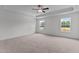 Spacious main bedroom with neutral carpet, tray ceiling, and bright windows at 945 Alma Railway Dr # 559, Wake Forest, NC 27587