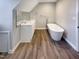 Modern bathroom featuring a double vanity and a freestanding tub at 101 Madeline Ct, Youngsville, NC 27596