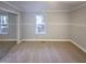 Neutral bedroom featuring a large closet with mirrored doors and a window view at 101 Madeline Ct, Youngsville, NC 27596