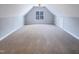 Spacious bonus room with a ceiling fan and large window at 101 Madeline Ct, Youngsville, NC 27596
