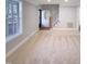 Open floor plan with staircase, light-filled entry and neutral color palette at 101 Madeline Ct, Youngsville, NC 27596