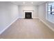 Cozy living room featuring a fireplace, carpet flooring, and plenty of natural light at 101 Madeline Ct, Youngsville, NC 27596