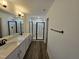 Modern bathroom with double vanity, quartz countertop, and shower with glass door and black trim at 1021 Prominence Dr., Homesite 20, Durham, NC 27712