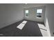Well-lit bedroom featuring neutral carpet, white walls, and large windows with scenic outdoor views at 1021 Prominence Dr., Homesite 20, Durham, NC 27712