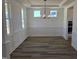 Bright dining room featuring hardwood floors, large windows, modern lighting, and stylish wainscoting at 1021 Prominence Dr., Homesite 20, Durham, NC 27712