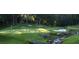 Golf course view with green grass, sand traps, a creek and trees at 1021 Prominence Dr., Homesite 20, Durham, NC 27712