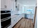 Modern kitchen with stainless steel appliances, white cabinets, and quartz countertops at 1021 Prominence Dr., Homesite 20, Durham, NC 27712