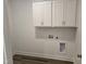 Functional laundry room with white cabinetry and modern hookups for washer and dryer at 1021 Prominence Dr., Homesite 20, Durham, NC 27712