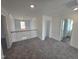 Upstairs loft area featuring plush carpet, natural light, and open floorplan at 1021 Prominence Dr., Homesite 20, Durham, NC 27712