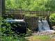 Charming old mill featuring a wooden water wheel and stone structure surrounded by greenery at 1021 Prominence Dr., Homesite 20, Durham, NC 27712