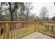 Relax on the wooden back deck with a lush green view through the trees at 109 Chatterson Dr, Raleigh, NC 27615