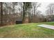 A large backyard and green space with a small storage shed, trees and plenty of room for entertaining at 109 Chatterson Dr, Raleigh, NC 27615