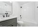 Modern bathroom featuring white subway tile, a gray vanity, and matte black hardware at 109 Chatterson Dr, Raleigh, NC 27615