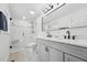 Modern bathroom with double vanity, sleek black fixtures, and a stylish glass-enclosed shower at 109 Chatterson Dr, Raleigh, NC 27615