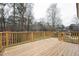 A view from a wooden deck, looking out over the lawn and surrounding woods at 109 Chatterson Dr, Raleigh, NC 27615