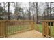 A close-up view from a beautiful wooden deck looking onto the wooded yard at 109 Chatterson Dr, Raleigh, NC 27615