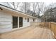 A close-up view from a beautiful wooden deck with sliding glass doors and a white exterior at 109 Chatterson Dr, Raleigh, NC 27615