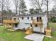 A view of the back of this home featuring a wooden deck and a grassy backyard at 109 Chatterson Dr, Raleigh, NC 27615
